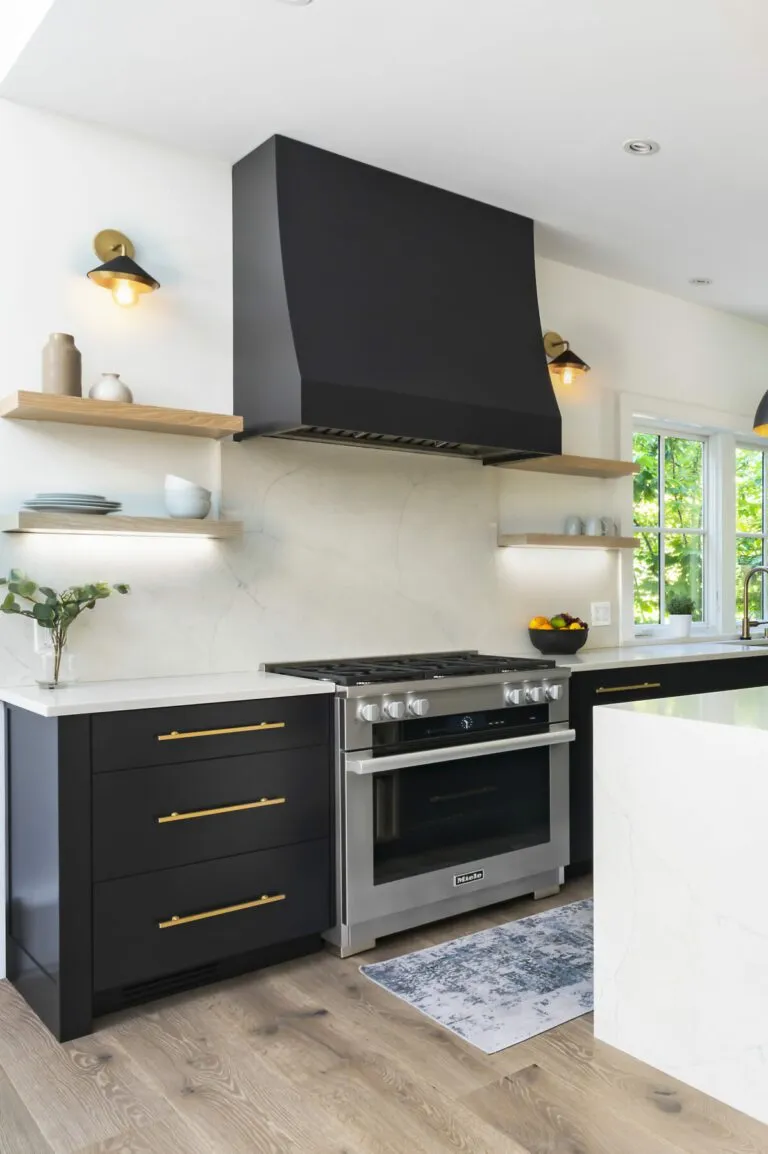 Contemporary kitchen featuring a large window, black cabinets, and marble countertops.