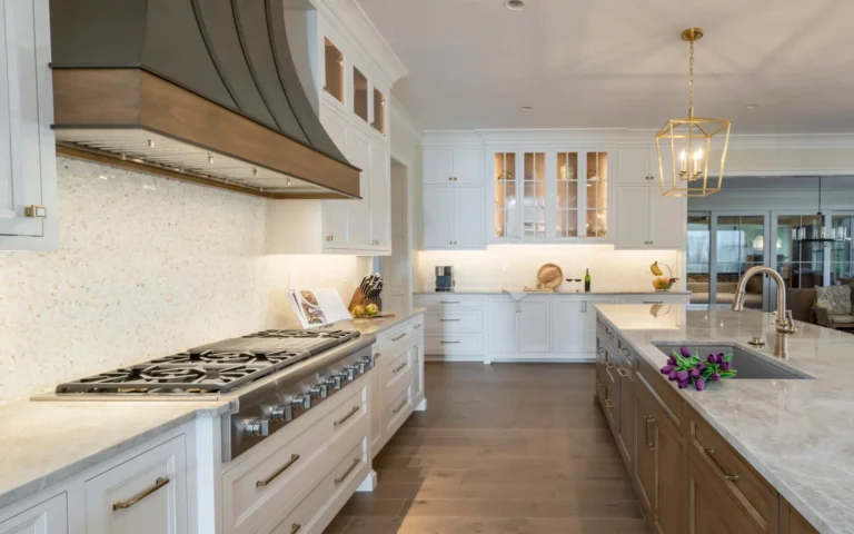 Luxurious modern farmhouse kitchen featuring white cabinets, gourmet appliances, and a large kitchen island